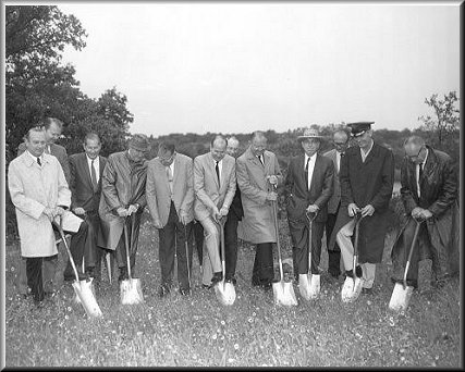 several men with shovels at groundbreaking 