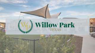 Photo of a shopping center with the City of Willow Park logo superimposed