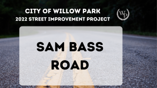 Photo of a road with text "Sam Bass Road"