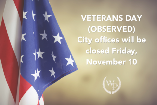 Photo of the American flag with the words "Veterans Day observed, city offices closed Friday, November 10"