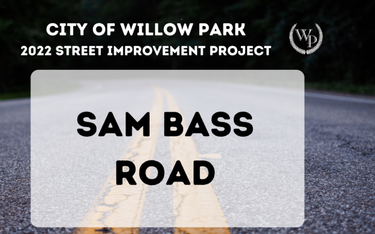 Photo of a road with text "Sam Bass Road"