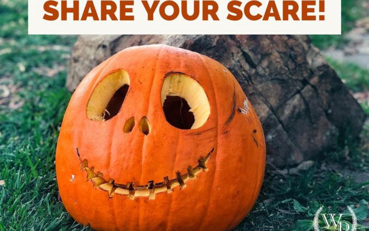 Carved pumpkin with title "Share your Scare"